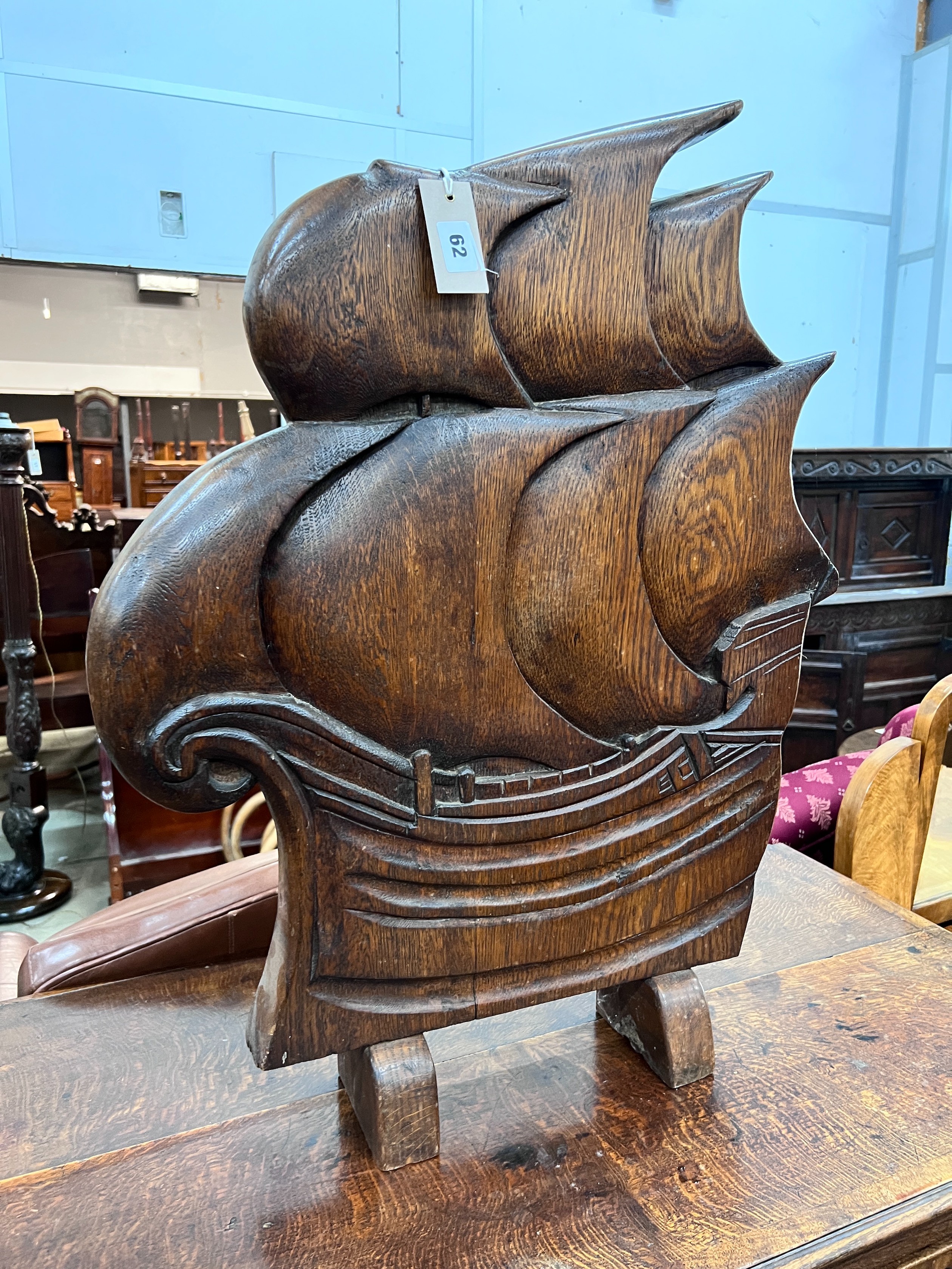 An Art Deco style carved oak firescreen in the shape of a ship, width 57cm, height 74cm *Please note the sale commences at 9am.